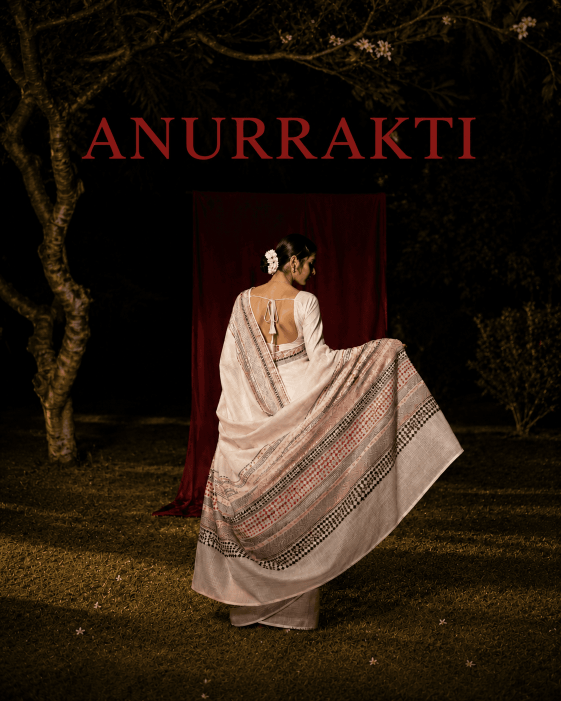 Model wearing a white saree in a night garden campaign frame